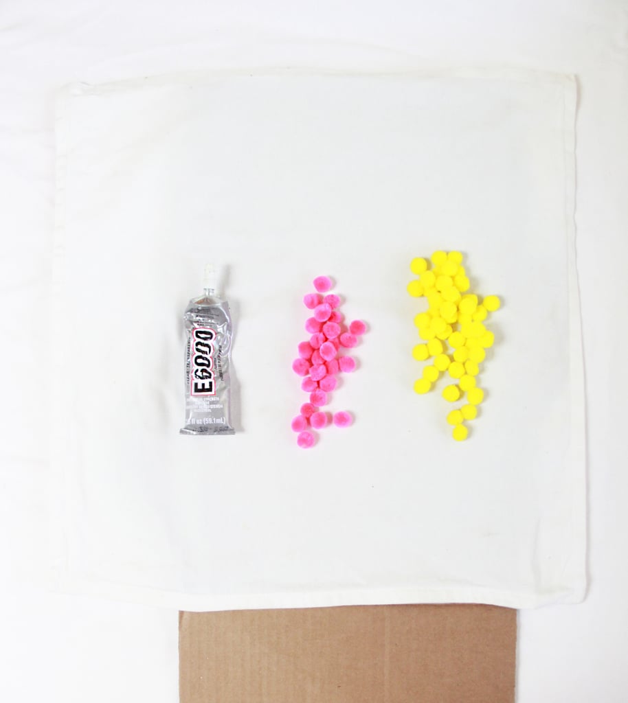 Supplies:
E6000 Craft Adhesive or another strong superglue
Pom-poms
Pillowcase (Ikea has inexpensive ones)
Cardboard