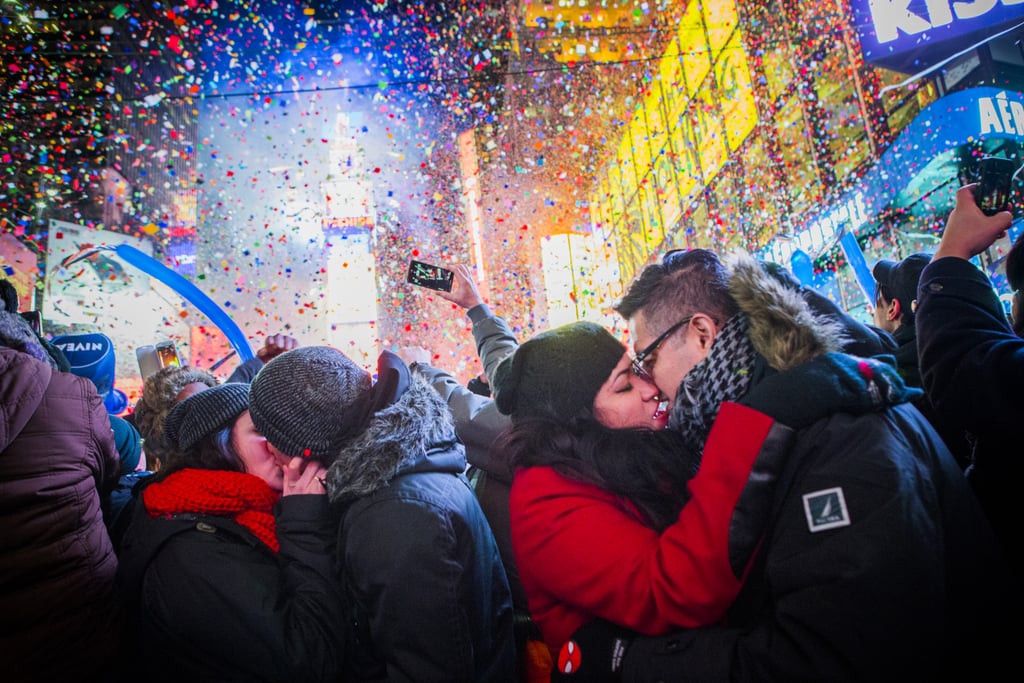 It was a streetside smooch for these pairs in New York City's Times Square.