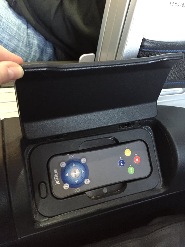 The remote is in the armrest, but the TV is also a touch screen.
The remote is in the armrest, but the TV is also a touch screen.