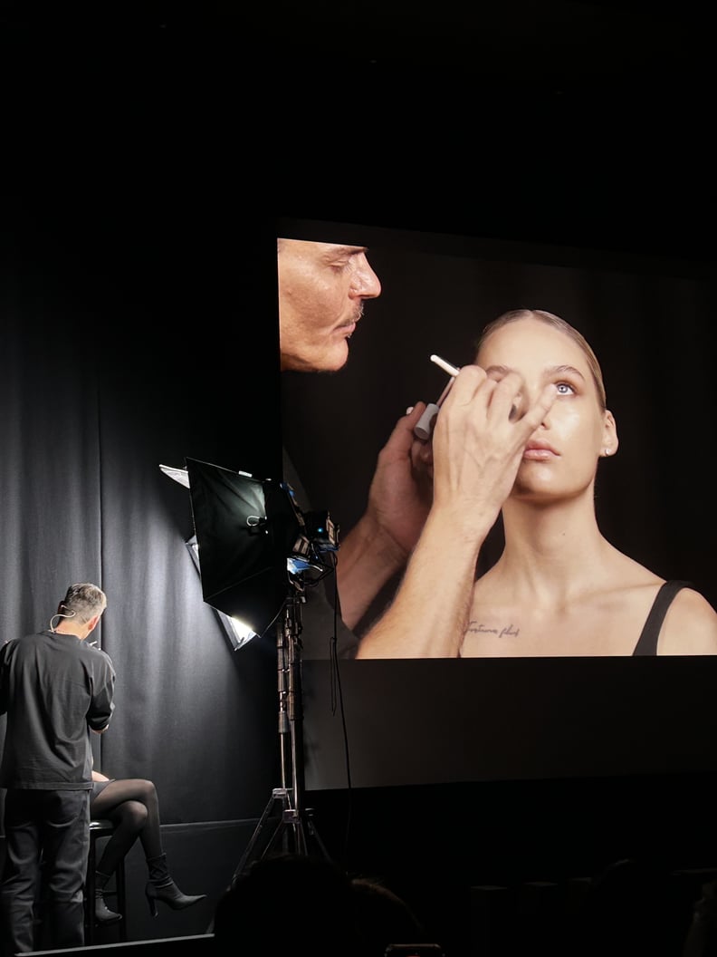 Mario dedivanovic applying makeup to a model on a big tv screen