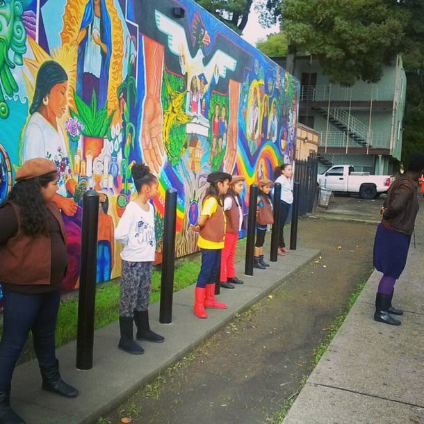 The Radical Brownies practice stepping in a colorful Oakland alley.