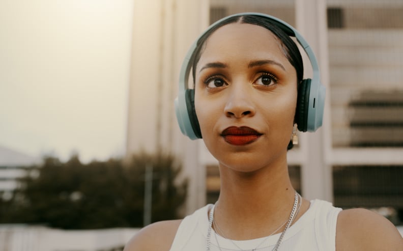 Woman With Headphones On Turned to Look Away From Camera