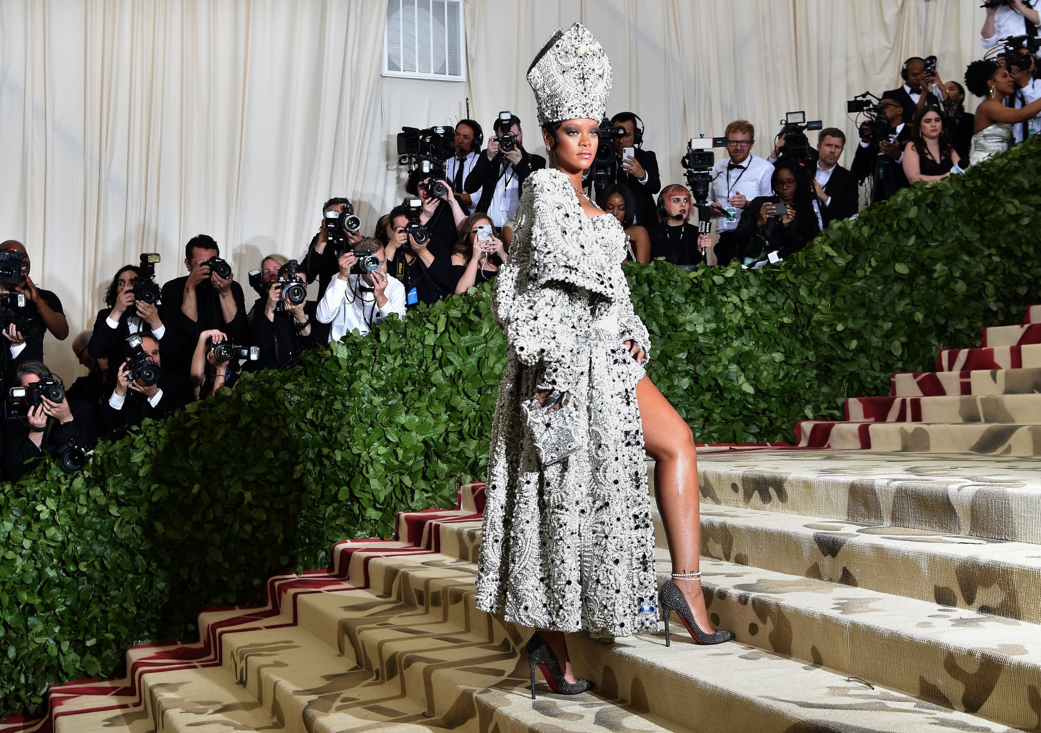 Rihanna arrives for the 2018 Met Gala on May 7, 2018, at the Metropolitan Museum of Art in New York. - The Gala raises money for the Metropolitan Museum of Arts Costume Institute. The Gala's 2018 theme is Heavenly Bodies: Fashion and the Catholic Imagination. (Photo by Hector RETAMAL / AFP)        (Photo credit should read HECTOR RETAMAL/AFP/Getty Images)