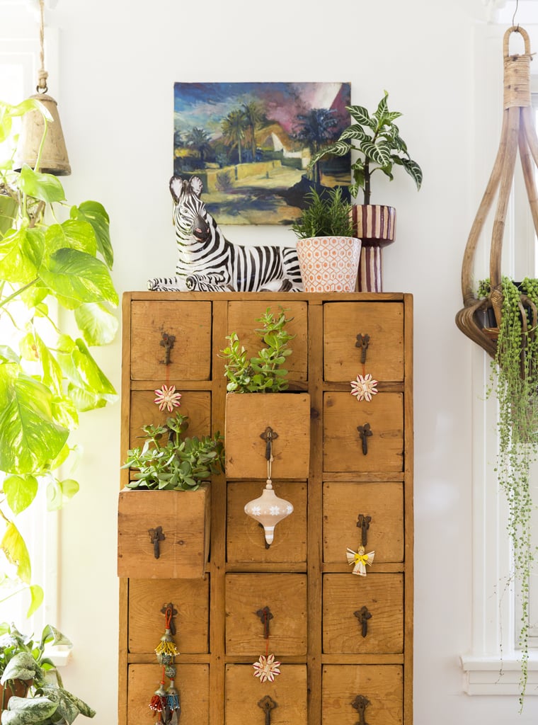 Justina elegantly updated everyday pieces in her home for the holidays by adding delicate ornaments. We love how ornaments look dangling from unexpected places, like this library card holder.