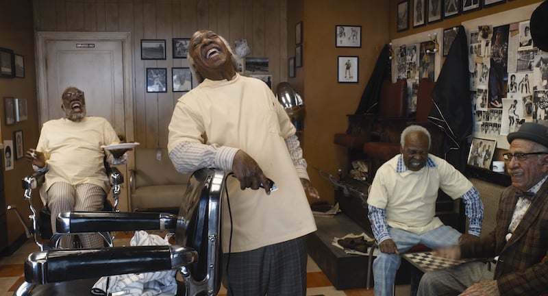 PS: Which were your favorite characters to dress?
RC: Definitely the barbershop guys. When Eddie came out of makeup as the old Jewish guy, I thought, "OK, I can check that box." I was having a moment. He was looking over at us, walking like the old guy, and it just blew my mind. Old people don't throw anything away, so we [dressed him in] some really old shoes and polyester pants and went vintage with his shirt, a little bit on the '70s side. It was very similar to how he looked in the first movie.
PS: How did you distinguish between the new and old Queens aesthetic?
RC: The cornermen were steadfast — they didn't change. Every once in a while, you'll go into a neighborhood and there's a Starbucks and a Gap and all these new places, but then there's one place that's the same. It was important to the story that the energy of Queens had changed, but the people that we know and love are still alive and well. 
It was important to the story that the energy of Queens had changed, but the people that we know and love are still alive and well.
PS: Where did you source the jewelry? KiKi Layne looks amazing in the movie.
RC: I used a lot of jewelry designers: Appetite Of A Millionaire, Laurel DeWitt, Loza Maléombho . . . everything was custom-made. I have a list of about 40 different African designers and jewelers that we went out to. Sewit Sium did [Layne's] nose ring and Nefertiti earrings. It was KiKi's idea to have the nose septum ring that she wears. She wanted her jewelry to be very unique. 
PS: Did you create any merch with Akeem's face on it?
RC: We did! We also had some agbadas, the celebratory African drapes with prints of their leaders. We put Akeem's face on several things: flags, T-shirts. We just can't sell them afterwards, because they have Eddie Murphy's face on them. [Laughs]
PS: You did however design a limited-edition bottle of Crown Royal ($25), which will be available to purchase.
RC: I immediately knew that I wanted to dress the box in a royal print with a 3D-printed lion head in the center. We also used the tribal print from Akeem's tapestry to create the pouch that the bottle is encased in. That's a collector's item!
Read on to see some of our favorite stills from Coming 2 America, playing at select drive-ins and streaming globally on Amazon Prime Video beginning March 5.
This interview has been edited and condensed for clarity.