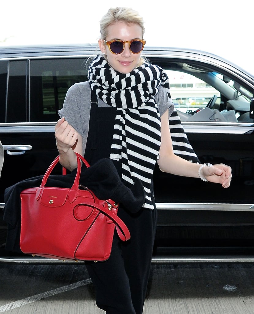 Emma Roberts smiled while making a glamorous arrival at LAX on Sunday.