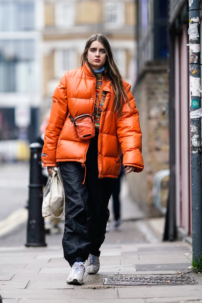 Style an Orange Puffer With Nylon Pants and White Kicks