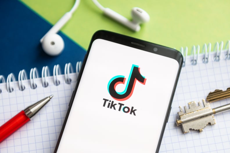 POLAND - 2021/02/09: In this photo illustration, a Tik Tok logo seen displayed on a smartphone with a pen, key, book and headsets in the background. (Photo Illustration by Mateusz Slodkowski/SOPA Images/LightRocket via Getty Images)