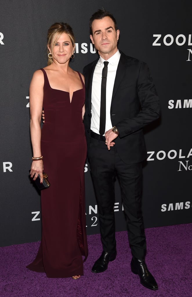 Justin Theroux and Jennifer Aniston wearing a Galvan dress, Sidney Garber jewels, Judith Leiber clutch, and Giuseppe Zanotti shoes.