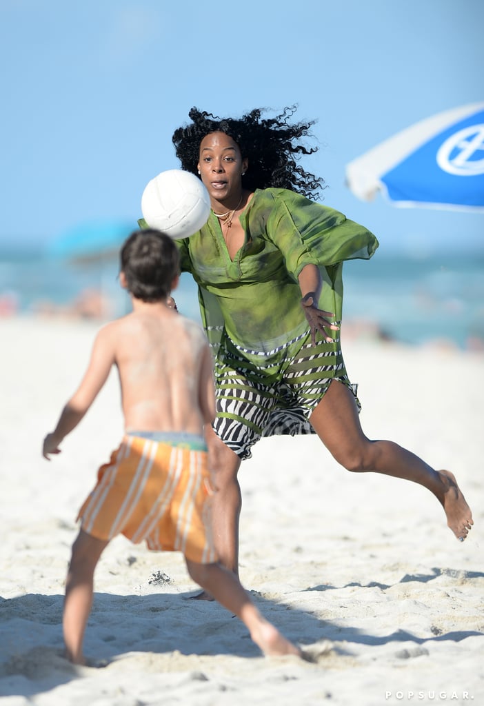 Kelly played soccer with kids on the beach.