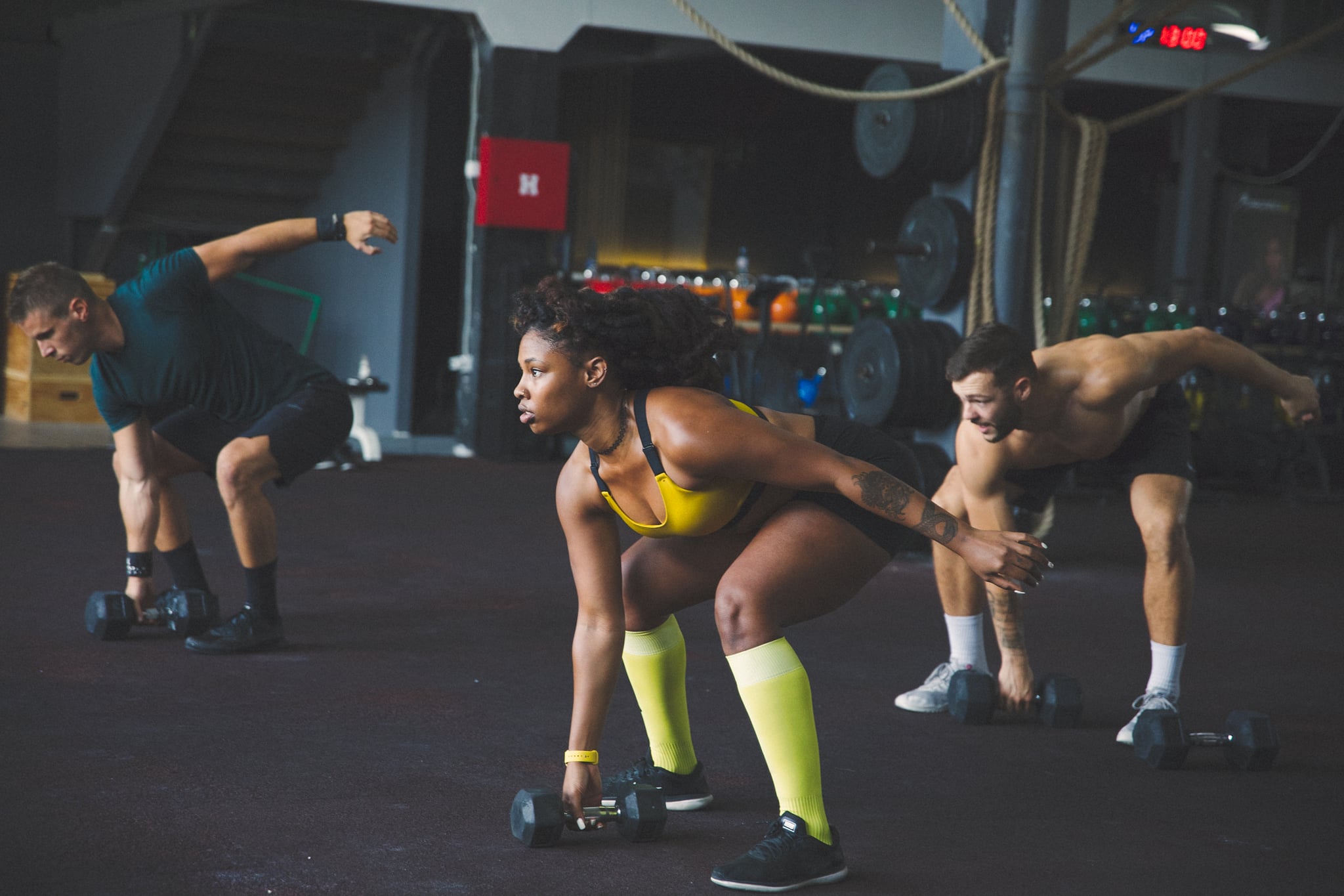 Woman particpates in weightlifting class.