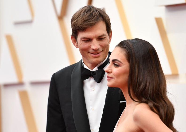 US actor Ashton Kutcher (L) and wife US actress Mila Kunis attend the 94th Oscars at the Dolby Theatre in Hollywood, California on March 27, 2022. (Photo by ANGELA WEISS / AFP) (Photo by ANGELA WEISS/AFP via Getty Images)