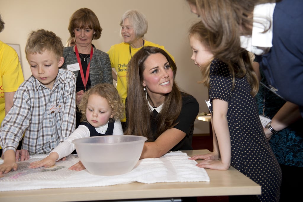 Kate listened intently to a little girl as she visited the offices of Child Bereavement UK in March 2016.
