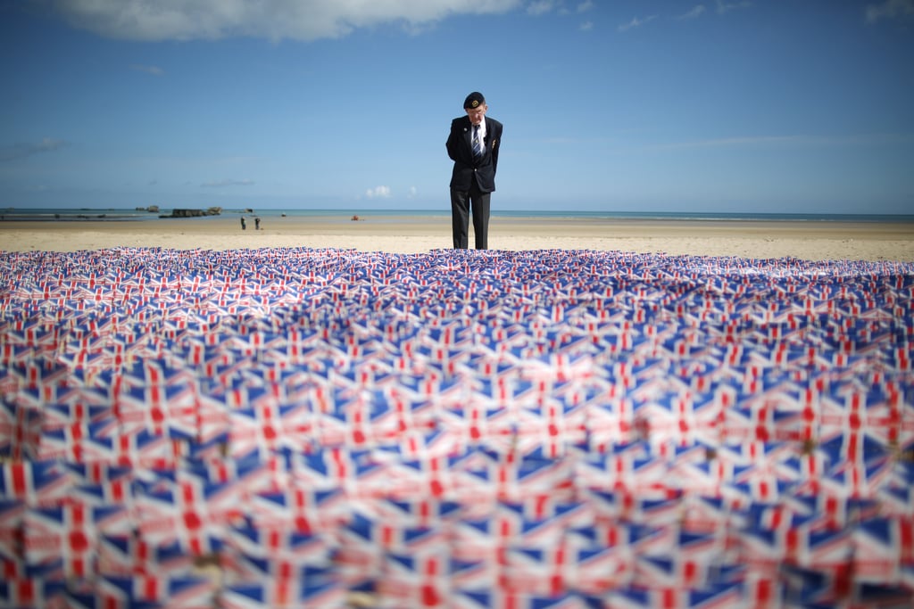 A WWII veteran stood by 20,000 paper flags that were on display near Asnelles, France, to honor those who lost their lives on D-Day 70 years ago.