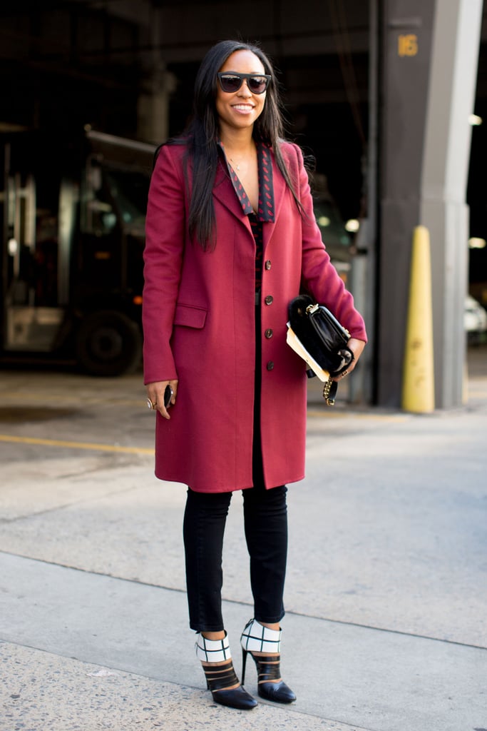 Shiona Turini dressed up her trousers with a cranberry coat and a pair of ultrachic black-and-white heels.