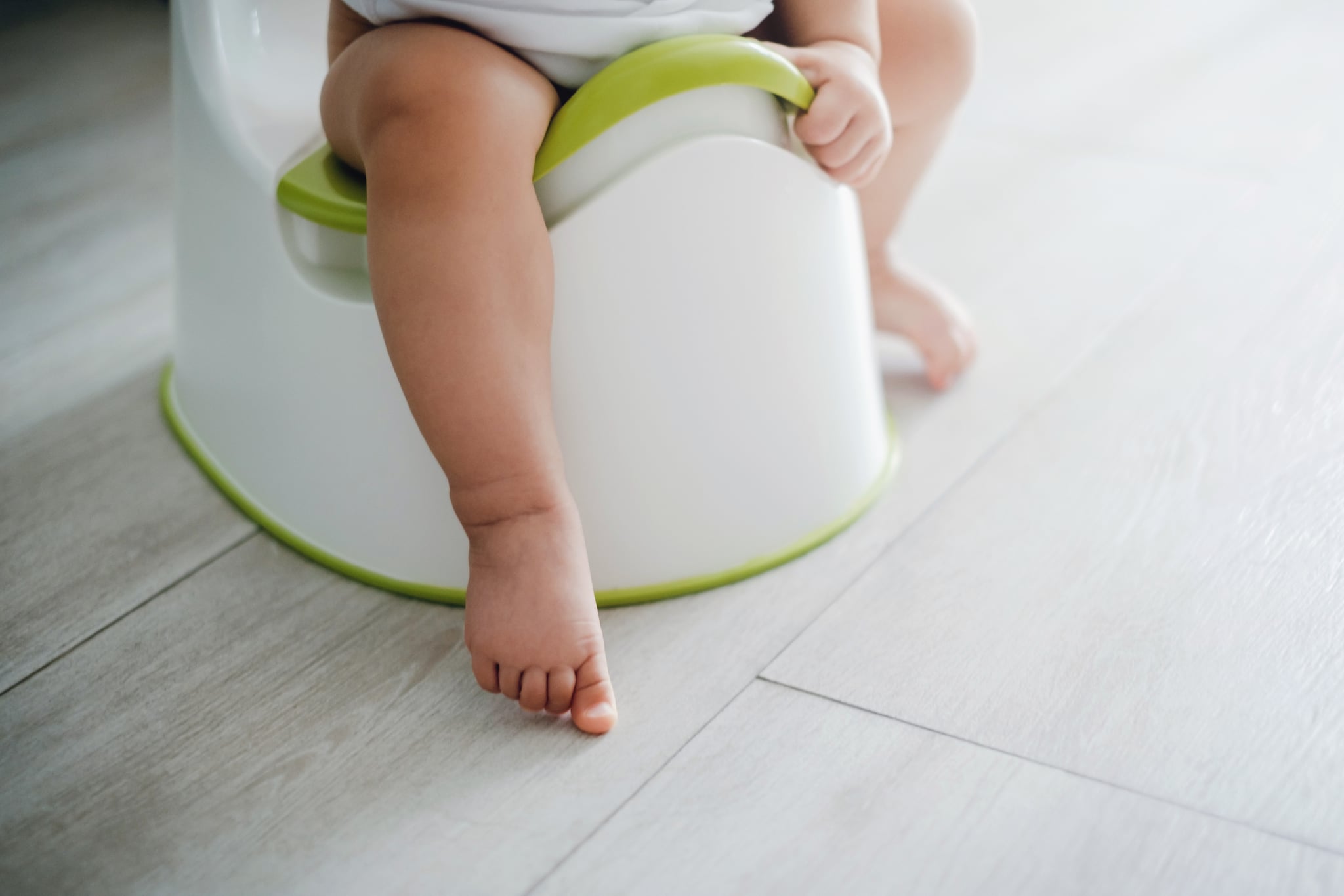 Close up of a toddler sitting on a potty chair on potty training