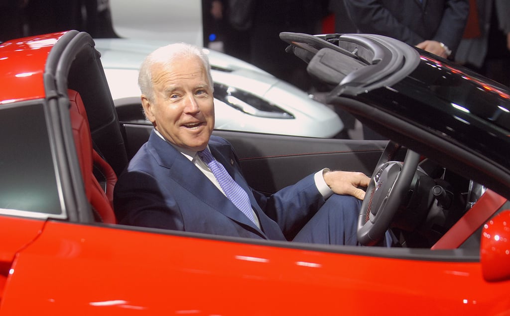 He looks pretty comfortable in a red convertible.