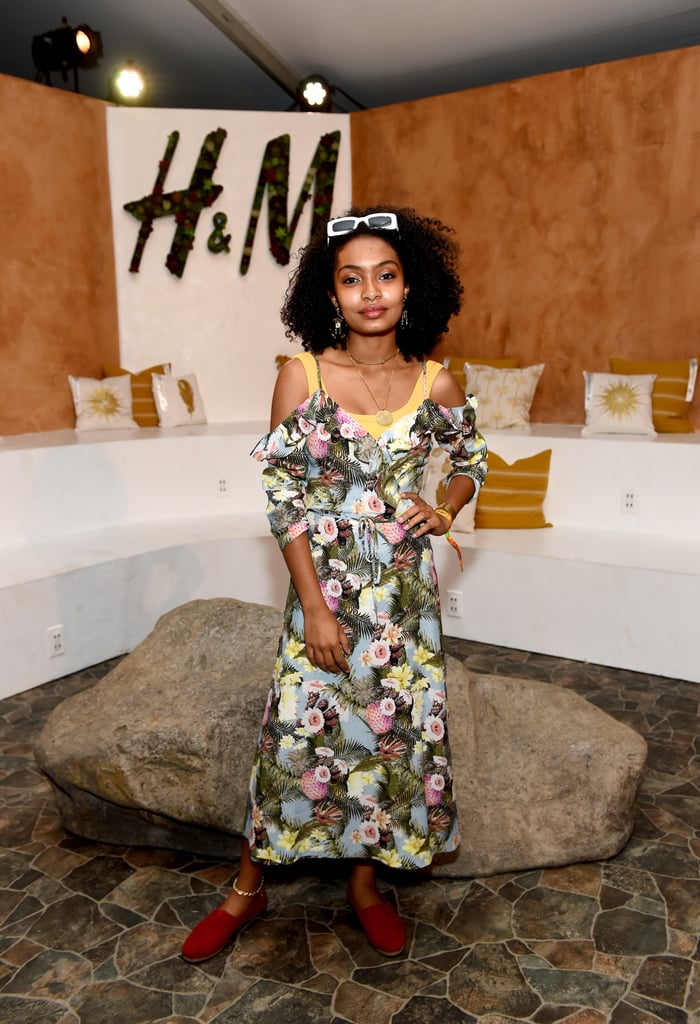 Yara Shahidi wearing a floral dress and flats at the H&M Loves Coachella tent. 