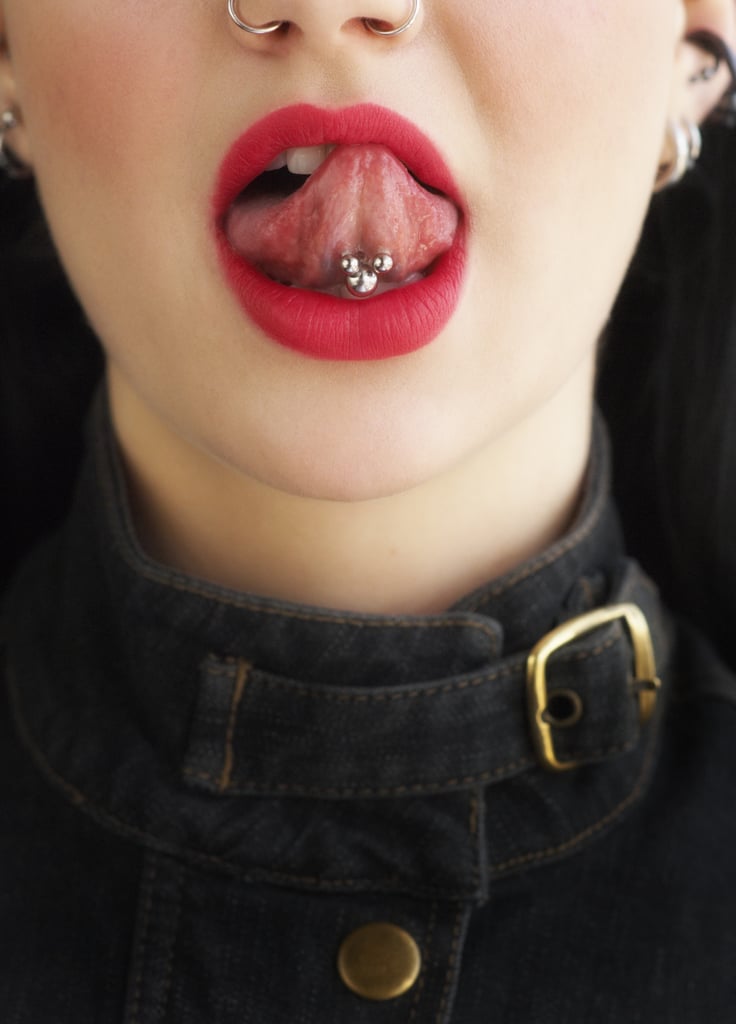 How Long Does It Take For Tongue Piercings to Heal?
This goes for all piercings, but the healing process is dependent on a couple of different things: where the piercing is located and how you care for it in the weeks and/or months after getting it. According to Beal, tongue piercings generally take four to six weeks to heal, and as mentioned before, you'll likely experience a little discomfort from swelling in the days and weeks that follow.
Are There Any Risks Associated With Tongue Piercings?
In general, there isn't much to fear about getting a tongue piercing in comparison to any other place on your body. The key is to do your research to ensure you're visiting a licensed piercer at a reputable parlour — in addition to a "well-placed piercing, the appropriate anatomy, and appropriate jewellery," said Beal — to minimise risks. And of course, make sure you're properly cleaning the area during the healing process to avoid infection.