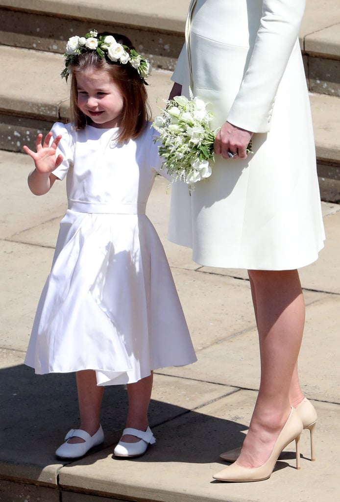 Charlotte waved to Harry and Meghan as they took off on their carriage procession.