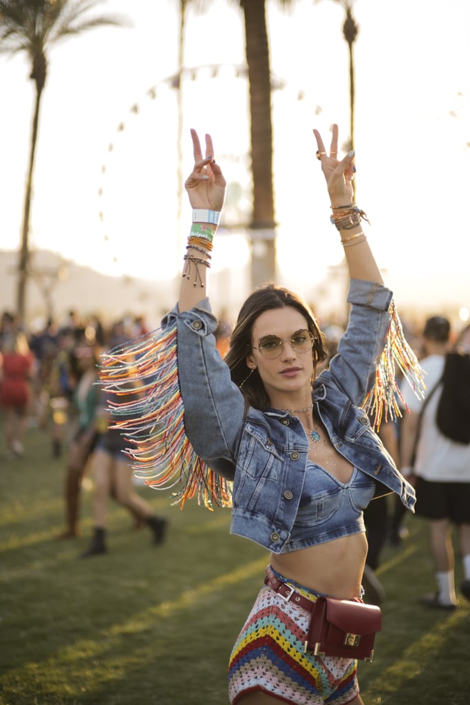 Alessandra Ambrosio dancing in a fringed denim jacket.