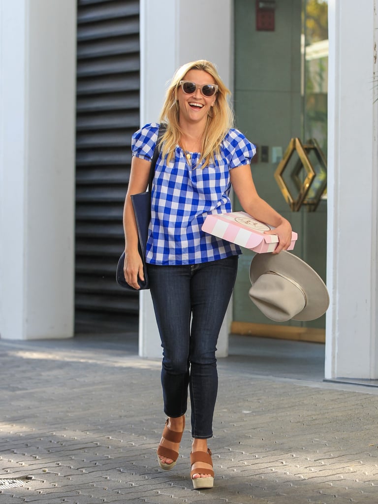 Reese's gingham print is as bold as can be, and she tops it off with a charming wide-brim hat.