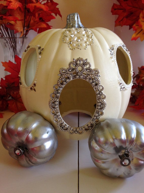 Recreate Cinderella's pumpkin carriage by using a large white pumpkin and two spray painted mini pumpkins as wheels.