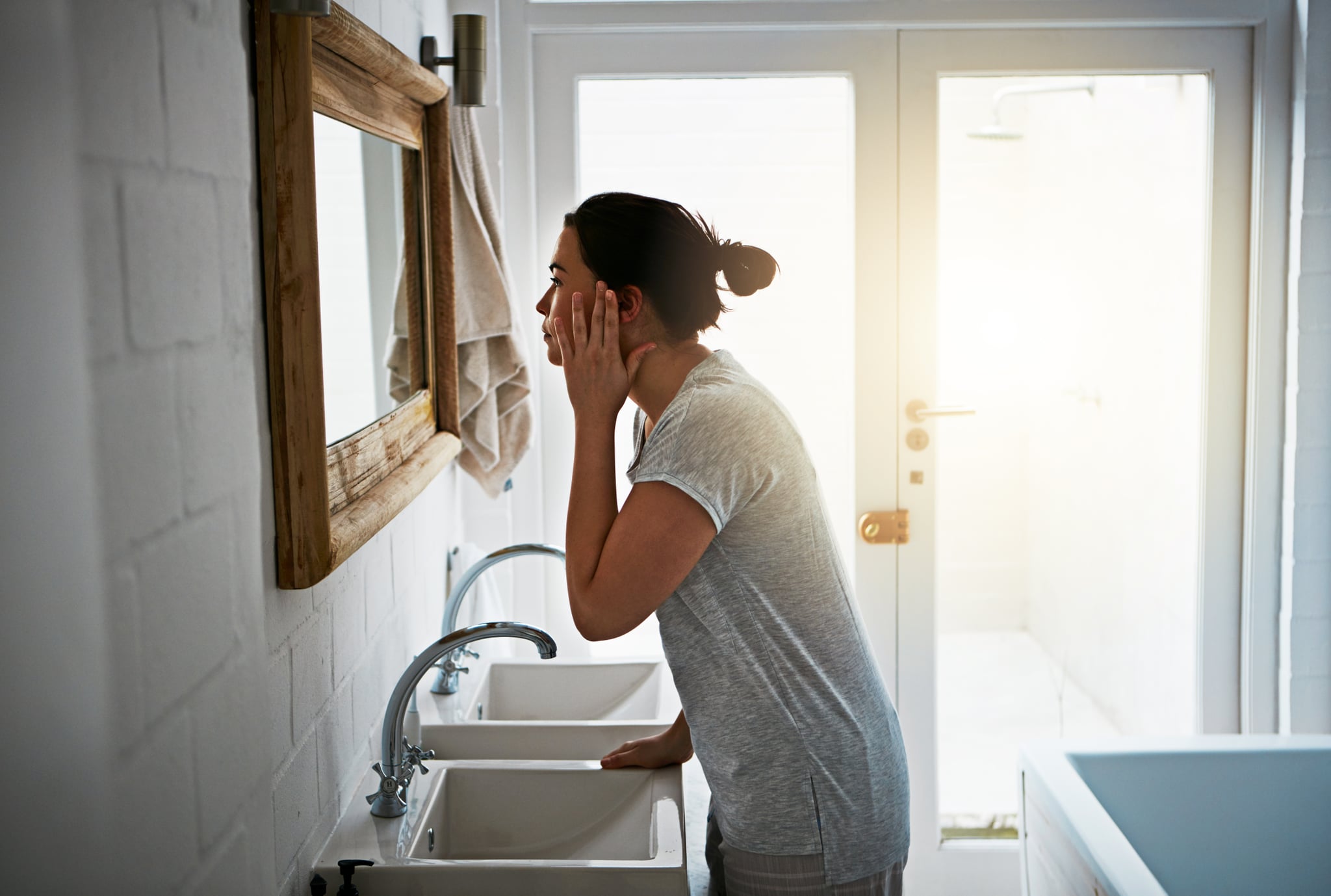 Cropped shot of an attractive young woman washing in the bathroom