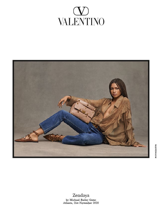Zendaya in jeans, the Valentino Ruffle-Trimmed Silk-Chiffon Blouse, Valentino Roman Stud Calfskin Ballet Flats, and the large beige Roman Stud The Shoulder Bag.