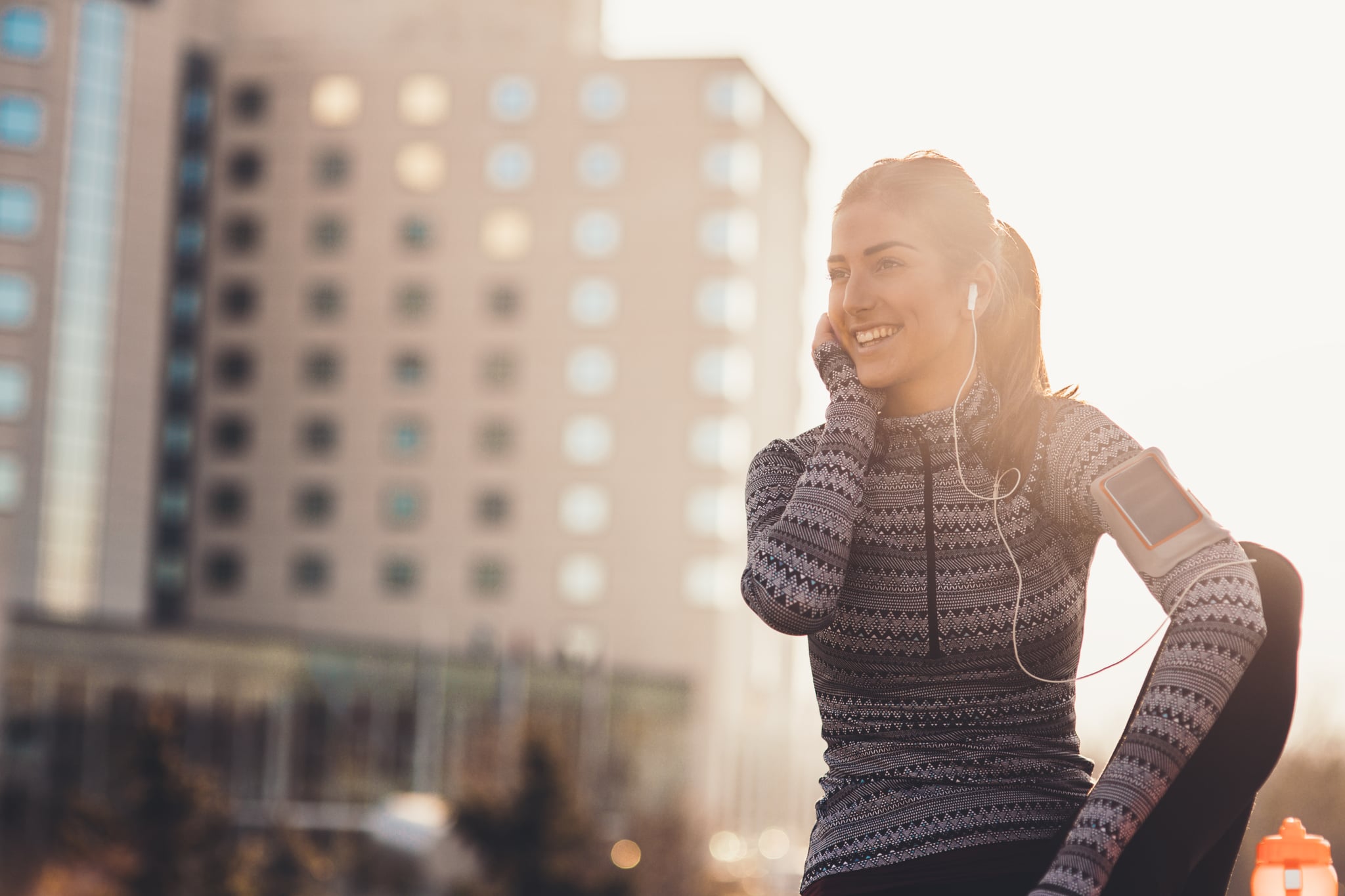 Young woman Enjoying music after hard work out outdoor in the city