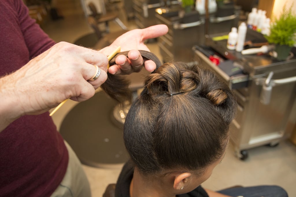 Finally, you want to sweep the sides and back upward. Make sure to secure the hair with a bobby pin first, then create the barrel curl and secure again.