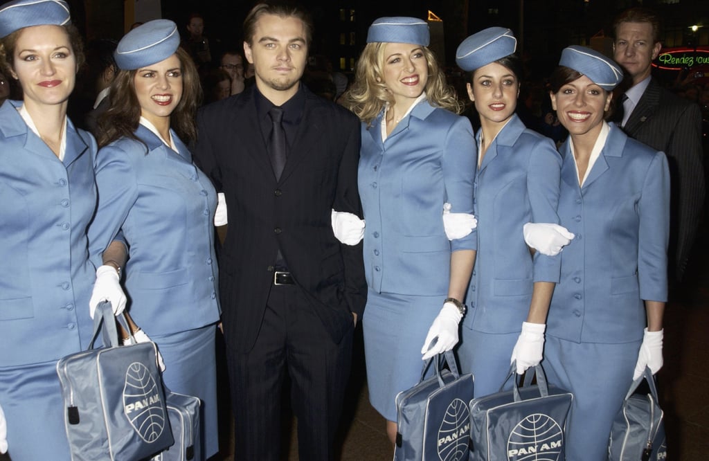 Leo stood with a gaggle of retro-chic flight attendants at the January 2003 UK premiere of Catch Me If You Can.