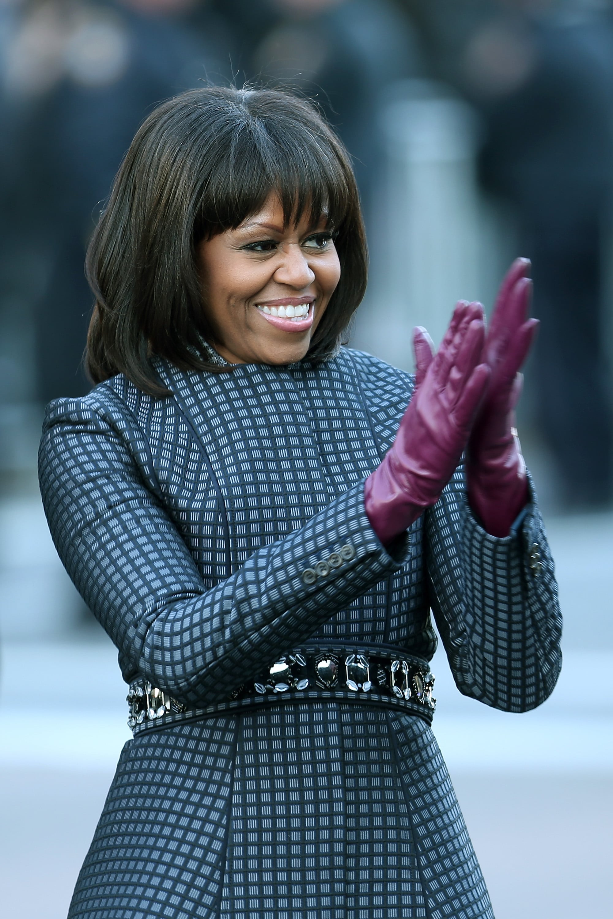 WASHINGTON, DC - JANUARY 21:  First lady Michelle Obama walks the route as the presidential inaugural parade winds through the nation's capital January 21, 2013 in Washington, DC. Barack Obama was re-elected for a second term as President of the United States.  (Photo by Chip Somodevilla/Getty Images)