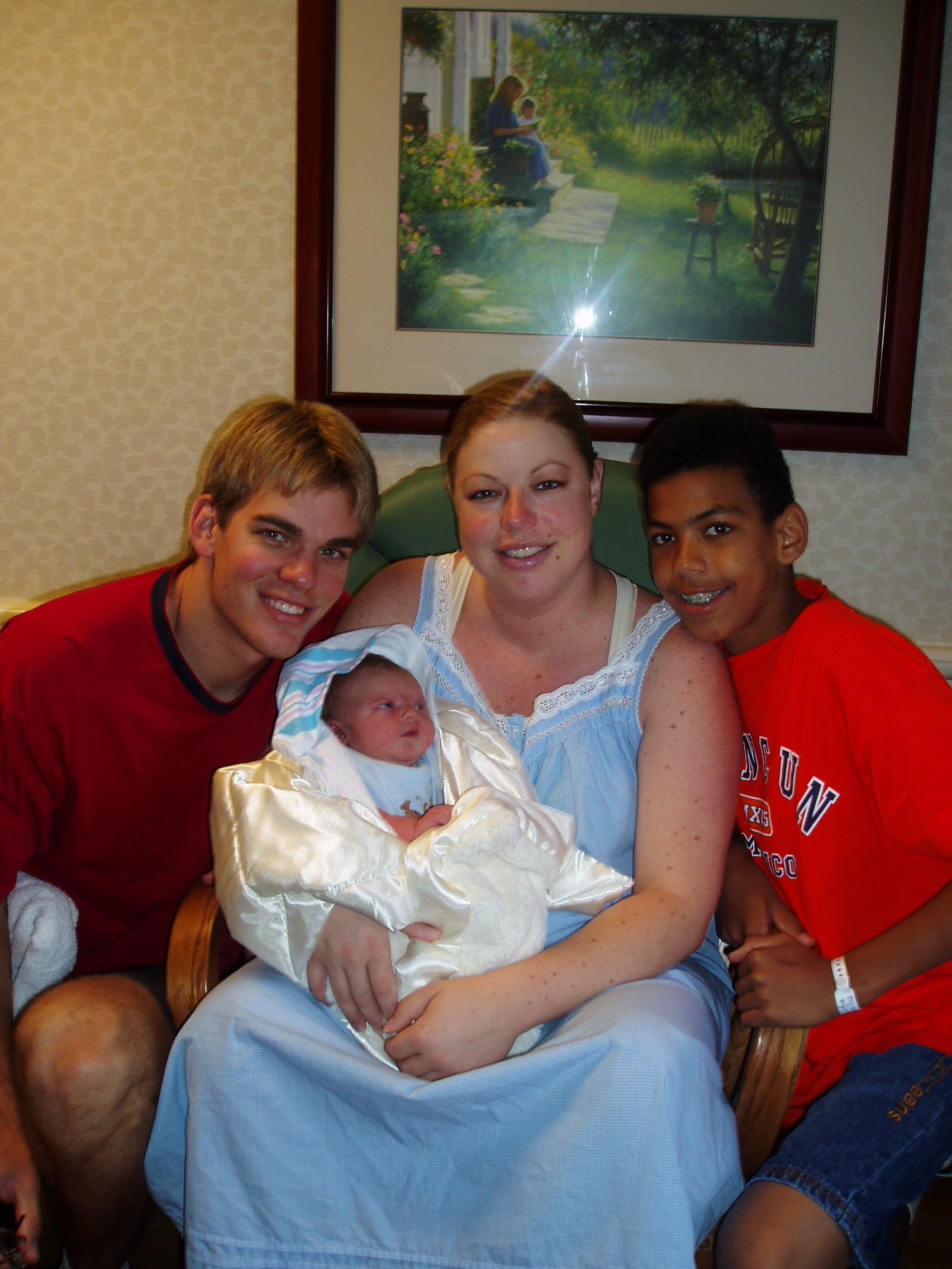 Raelyn Balfour holds her newborn son, Bryce, alongside her husband Jarrett (left) and her then 14-year-old son Braiden (right).