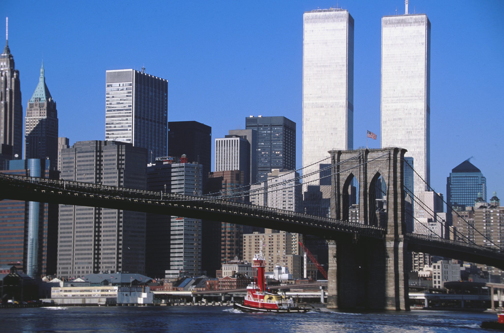 2001: Brooklyn bridge in the downtown of Manhattan and the World Trade Centre towers. (Photo by michel Setboun/Corbis via Getty Images)