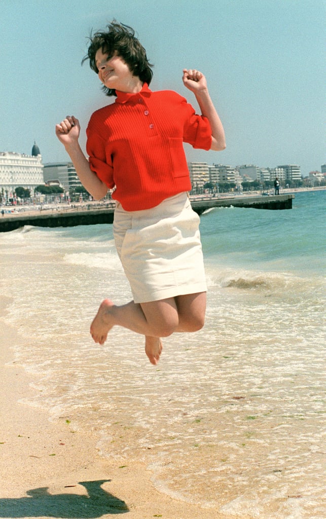 Juliette Binoche jumped for joy on the beach in 1985 — a pose she still loves to do to this day!