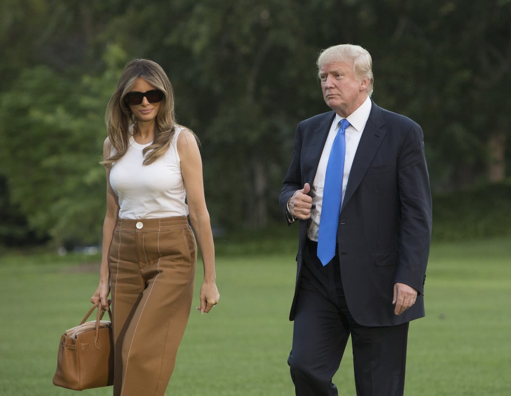 When Melania moved into the White House in June 2017, she arrived in Bally pants, a white Dolce & Gabbana tank, and Manolo Blahnik python pumps. She coordinated the look with two standout accessories: those dark, square sunglasses, which were about to become her signature, and an Hermès Birkin bag.