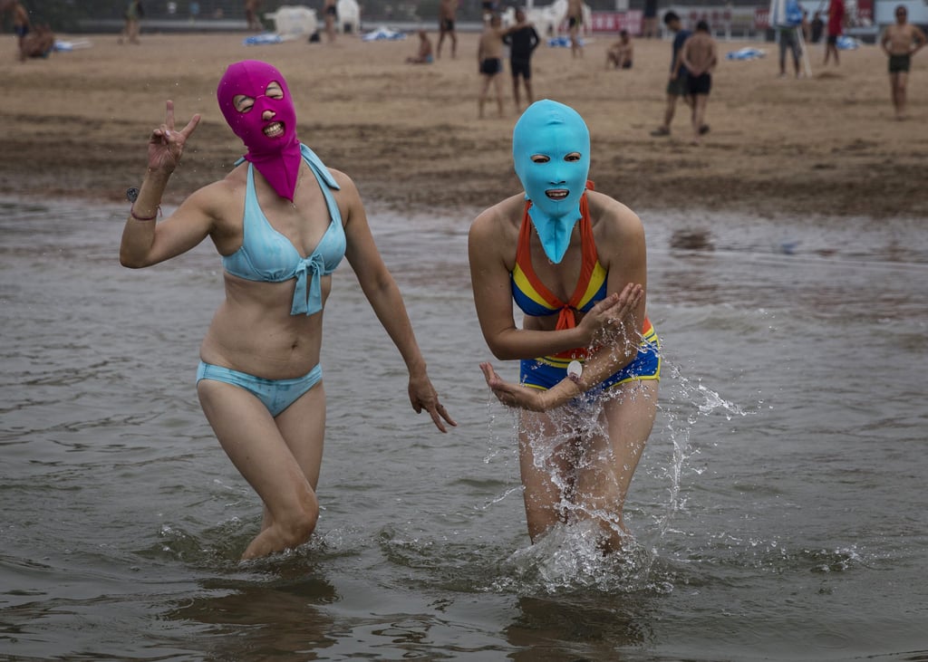 Women in China showed off the new "bikini mask" trend while swimming in the Yellow Sea.