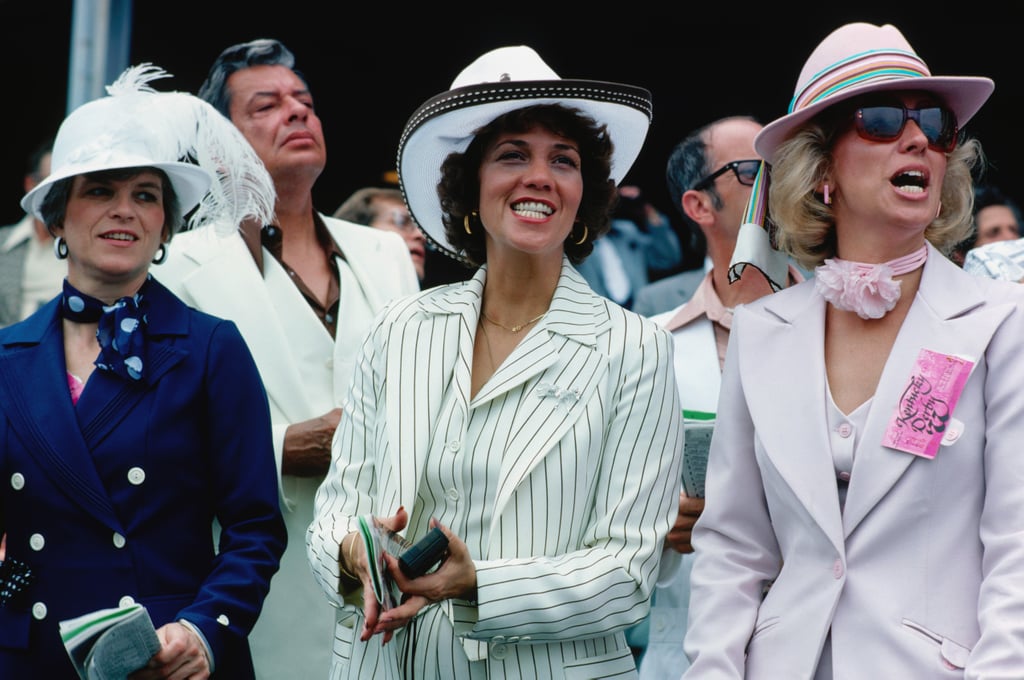 Three women in suits and hats cheered during the 1977 Kentucky Derby.