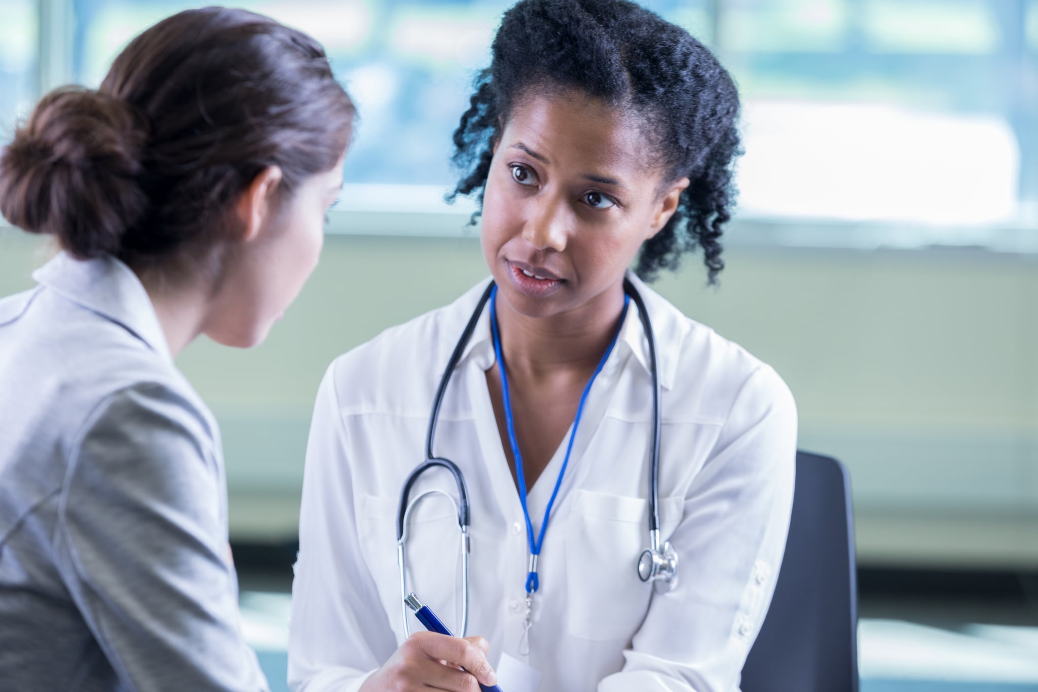 A compassionate female doctor with female patient