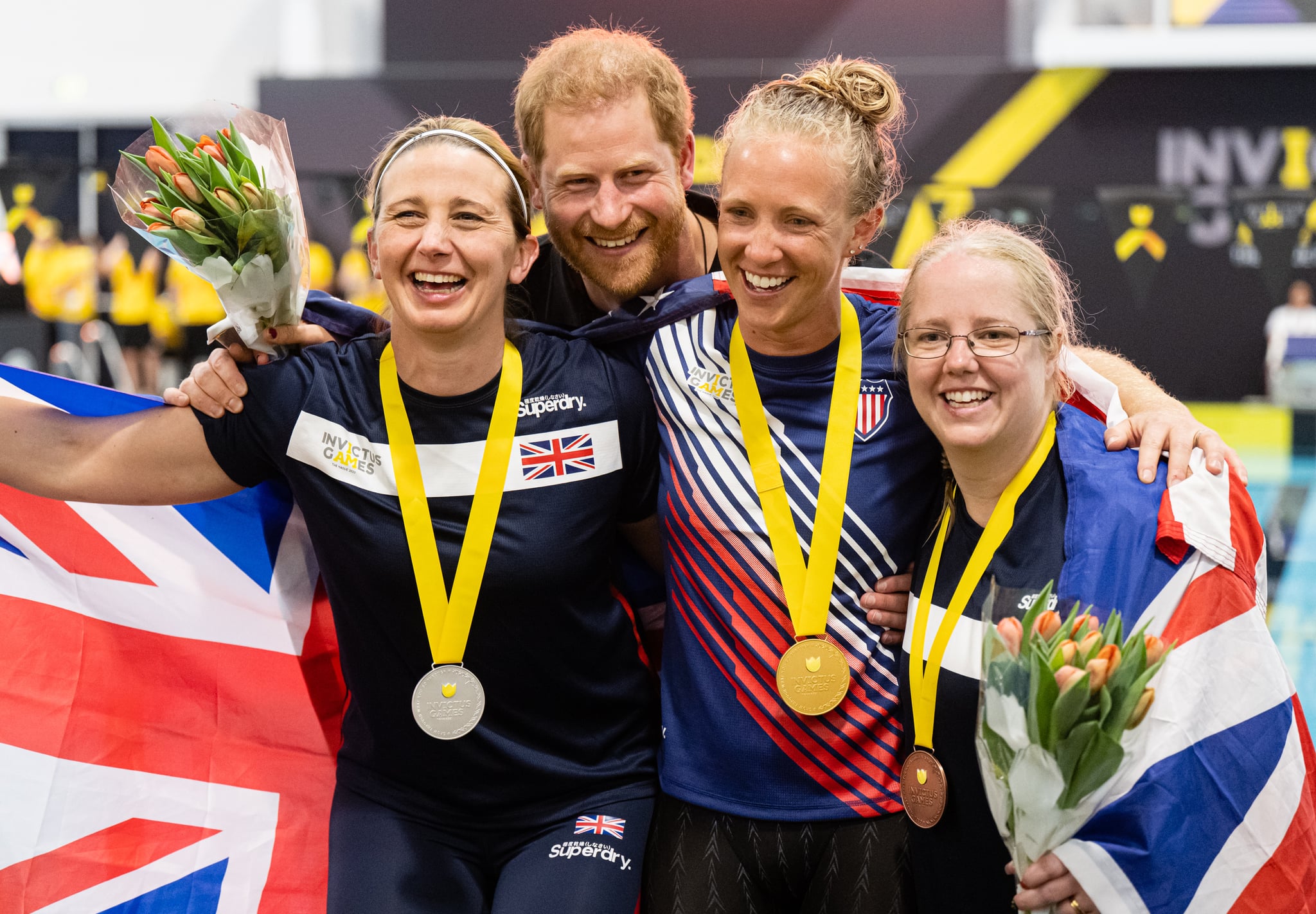 THE HAGUE, NETHERLANDS - APRIL 19:  Prince Harry, Duke of Sussex gives out medals at the swimming competition during day four of the Invictus Games The Hague 2020 at Zuiderpark on April 19, 2022 in The Hague, Netherlands. (Photo by Samir Hussein/WireImage)