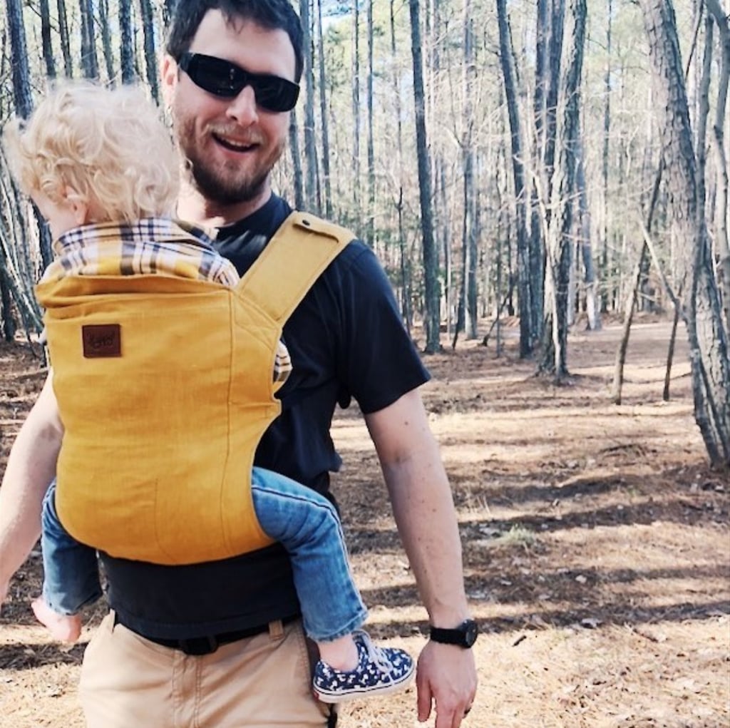 A smiley dad rocking a baby carrier is all we need in this life.