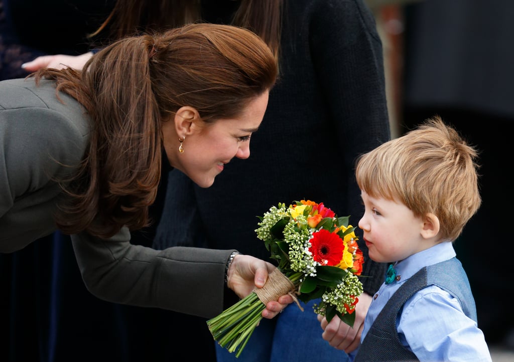 Kate let a little boy sniff the flowers he gave her during a walkabout in North Wales in November 2015.