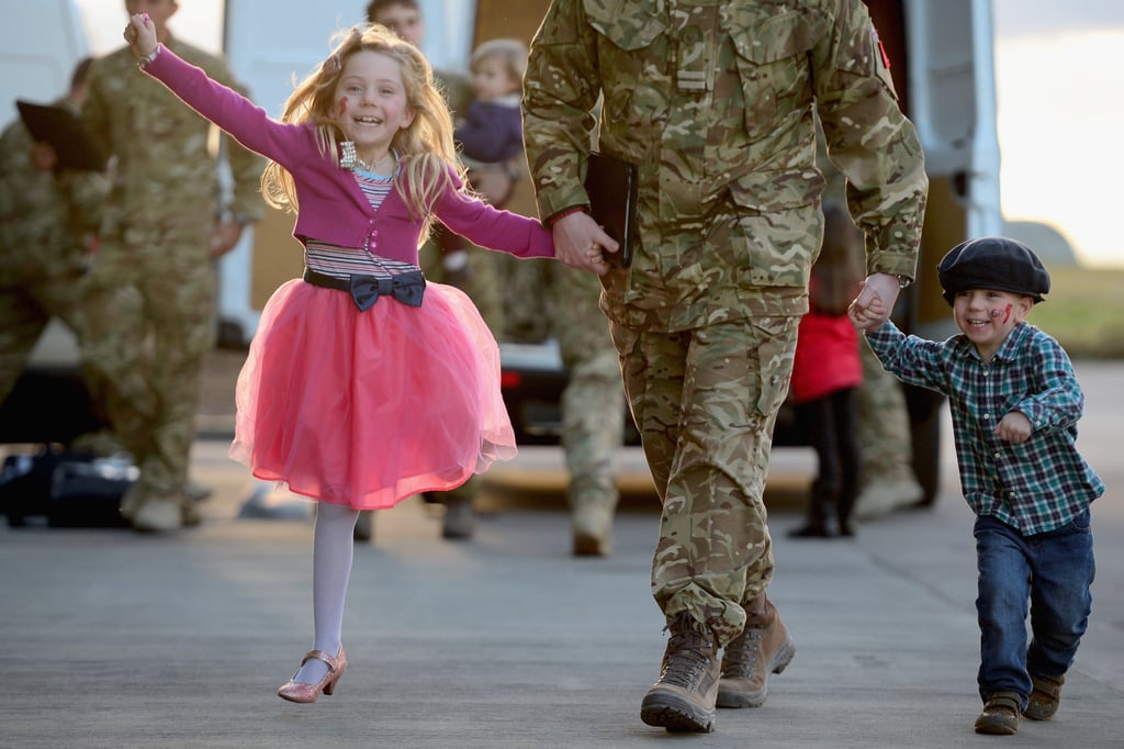 Two kids walked hand in hand with their dad when he arrived.