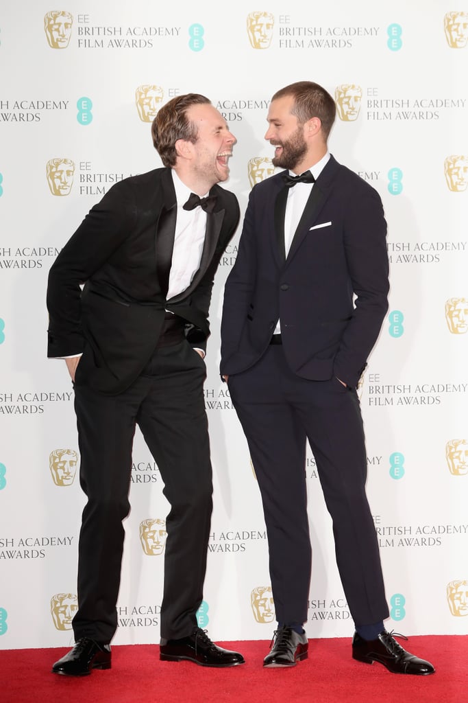 Rafe Spall and Jamie Dornan laughed at the BAFTA Awards together.