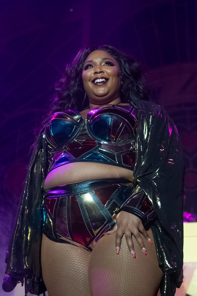 Lizzo wows in a glitzy purple leotard and shimmering cape as she