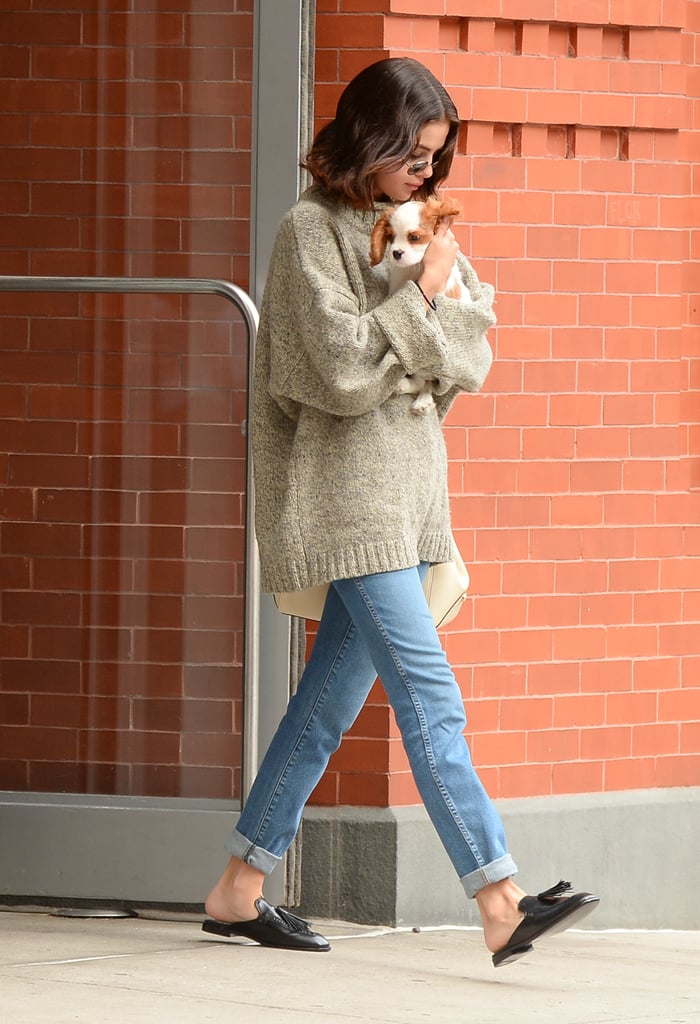 Selena stayed cozy in her sweater and cuffed jeans while holding her new puppy Charles. The star gave her sneakers a break by slipping into black open-back tassel loafers.