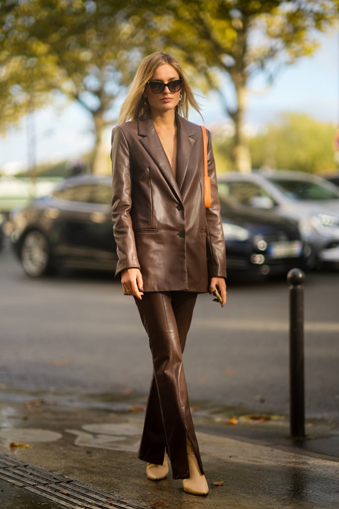 Making a fashionable entrance is as simple as throwing on a sharply tailored leather suit. But there's more? The split hem of the pants makes this look a step above the rest. Whether you wear the blazer on its own or style it over a turtleneck or fitted bustier, you will look undeniably elegant.