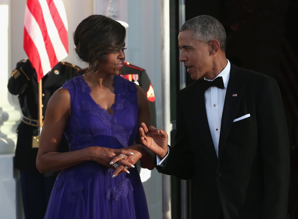 We're guessing the president is complimenting his wife on her beautiful dress.