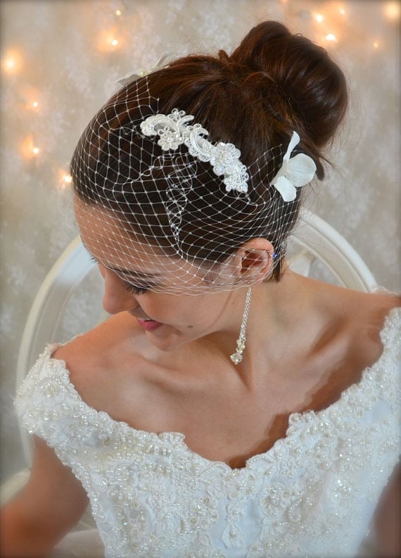 This comb ($32) has it all: lace, sheer sequins, and pearls. Wear it as is, wear with a satin ribbon, or use it over the comb of a birdcage veil.